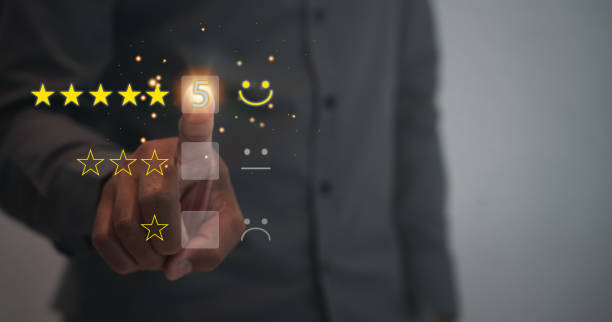 istock Customer service and Satisfaction concept ,Business people are touching the virtual screen on the happy Smiley face and giving star icon to give satisfaction in service. rating very impressed. 1417990900