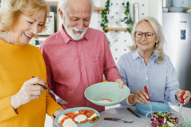 istock Senior preparing food and enjoying lunch 1417991148
