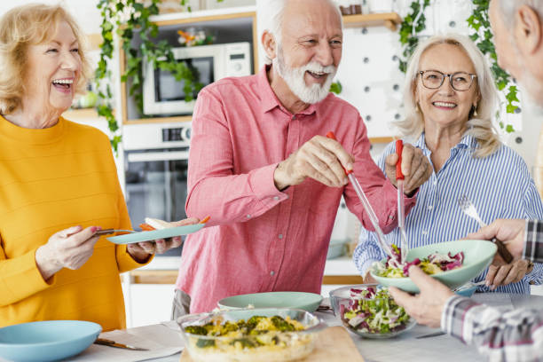 istock Cheerful seniors having lunch at home 1417991220