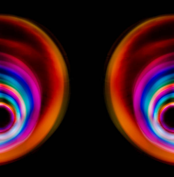 istock Multicolored light circles of different colors, yellow blue, red, blurred circle on a black background, photo was taken with a long exposure when the lanterns of rainbow colors were twisted 1417992452