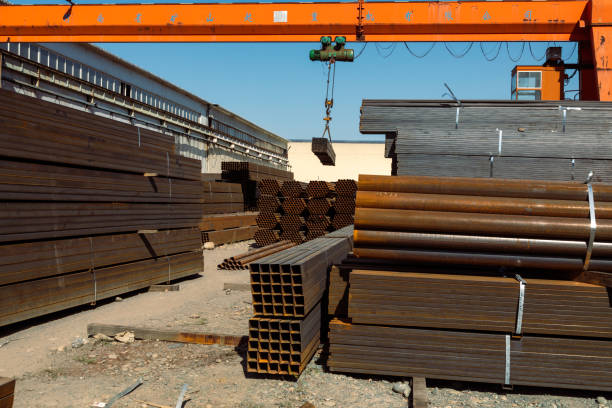 istock Gantry crane transporting stack of metal pipes 1417994054