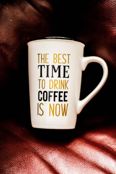 istock Closeup of a white cup with a note about drinking coffee of a leather surface 1417994252