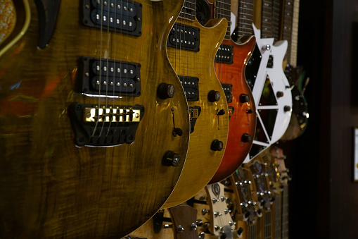 electric guitars hanging in the store. variety of electric guitars