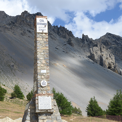Col d'Izoard (2,360 m (7,743 ft)) is a mountain pass in the French Alps. There are forbidding, barren scree slopes with pinnacles of weathered rock on the upper south side known as the Casse Déserte. On the Col d'Izoard (2,360 m (7,743 ft)) there is a memorial to Coppi and Bobet, two cycling heroes from the 1950-s. The col has formed a dramatic backdrop to some key moments in the Tour de France.