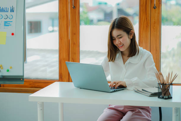 istock Attractive young Asian beauty accountant in office using laptop and financial documents on office desk. 1417999433