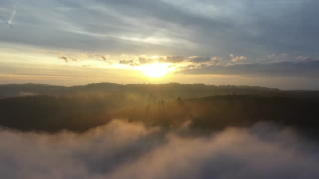 Sunset drone over mountain clouds