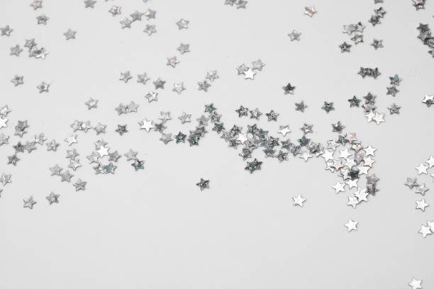 istock sparkles silver stars on white background with text place- Image 1418000017