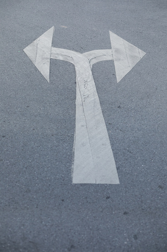 Doubled traffic arrow sign on street