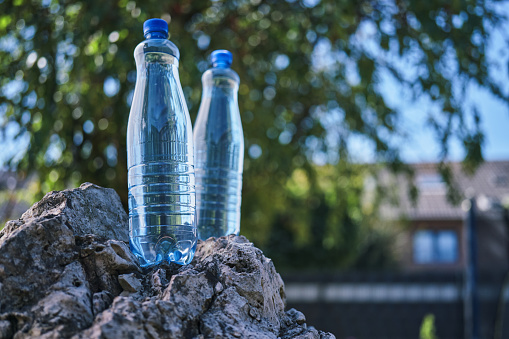 Water in Plastic Bottle with Park Background