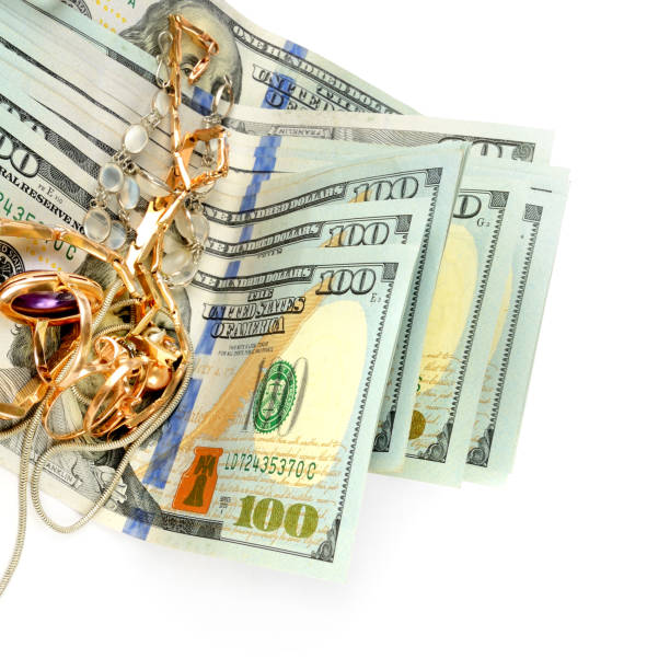 istock Dollars and jewelry isolated on white background. 1418010529