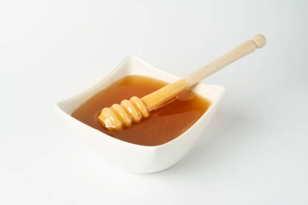 Honey with wood stick stock photo