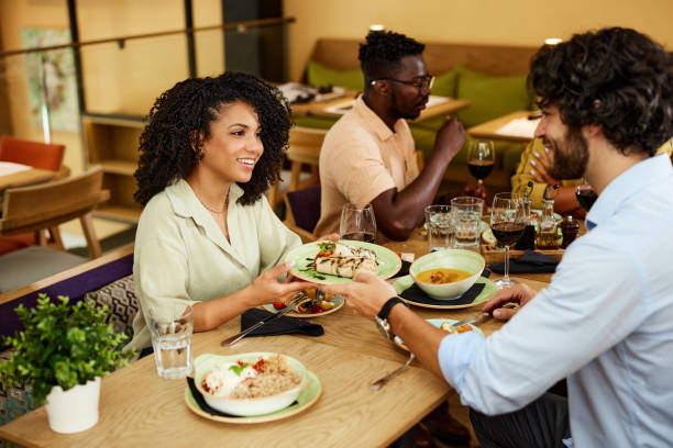istock A multicultural friends are having dinner with friends in a restaurant. 1418016580