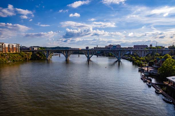 istock Old bridge on a big river flowing through the city 1418025772