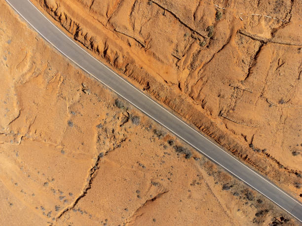 aerial view of asphalt straight road in wasteland desert stock photo