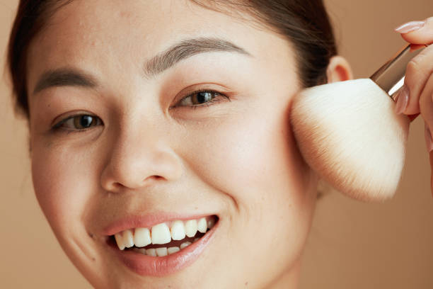 istock young asian female with makeup brush 1418029643