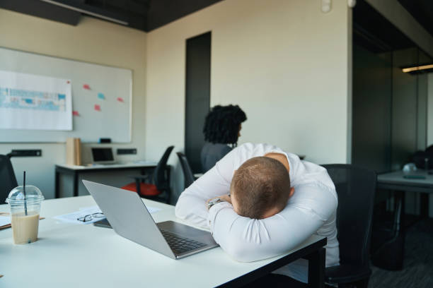 istock Tired man fell asleep at his desk in the office 1418031261