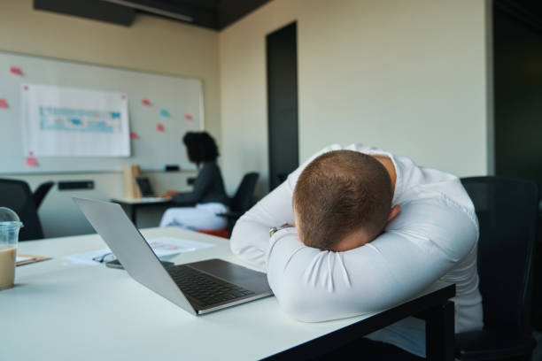 istock Man fell asleep at his desk in the office 1418031286