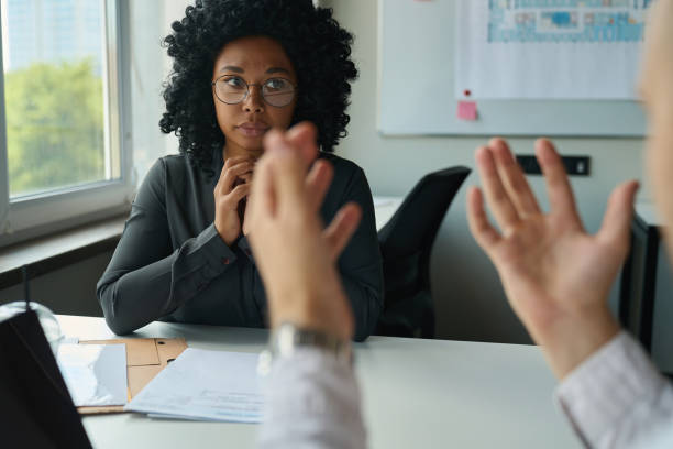 istock Woman and man in the office discussing a work project 1418031456
