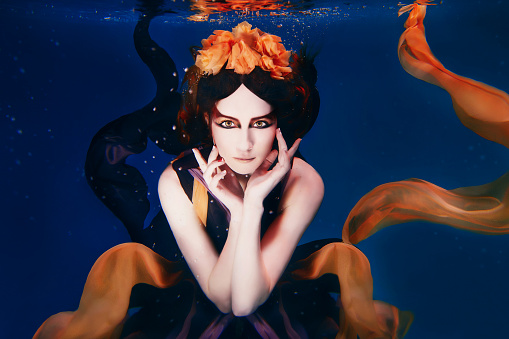 beautiful artistic young woman in dress dancing underwater. Mermaid, harvest, dance, fairy concept