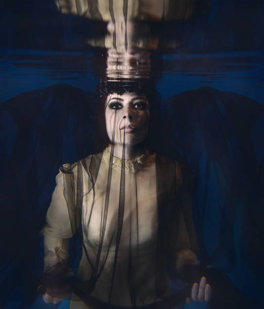 istock Gothic Spooky woman in black veil underwater 1418033364