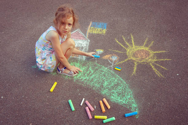 istock Child from Ukraine draws with chalk. 1418037257
