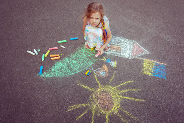 istock Child from Ukraine draws with chalk. 1418037444