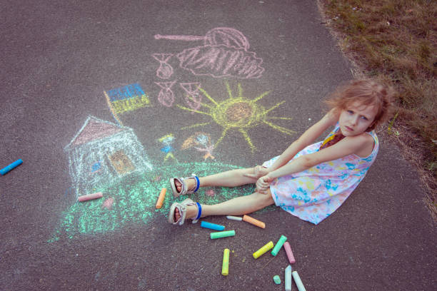 istock Child from Ukraine draws with chalk. 1418037563