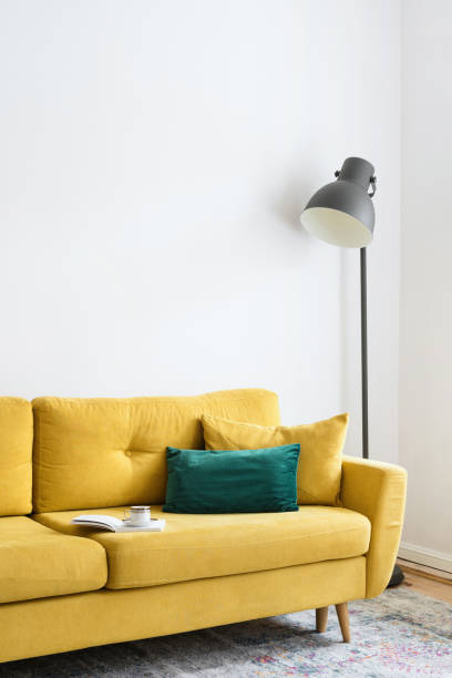 istock mustard velvet sofa with pillows and floor lamp 1418040336
