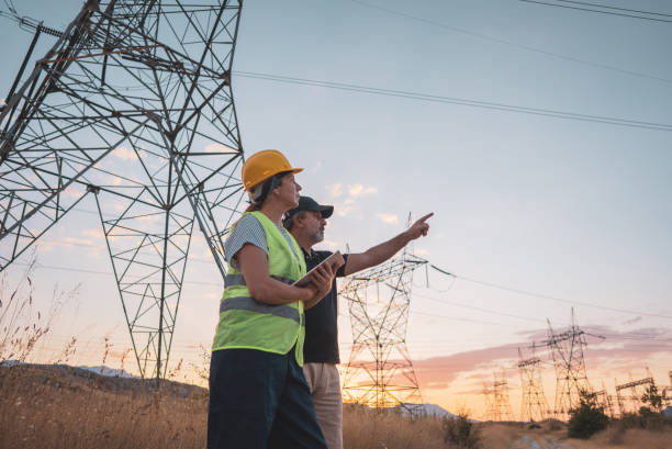 istock Couple engineers at the power station work at sunset. 1418043533