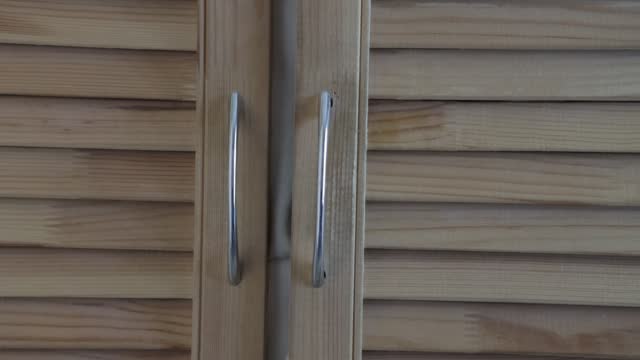 the doors of the blinds of a homemade wooden cabinet