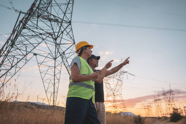 istock Couple engineers at the power station work at sunset. 1418043659