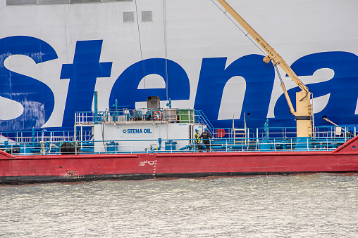 Gothenburg, Sweden - May 04 2022: Bunker ship Oljaren delivering fuel to a Stena Line ferry.