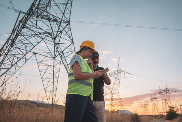 istock Couple engineers at the power station work at sunset. 1418043684