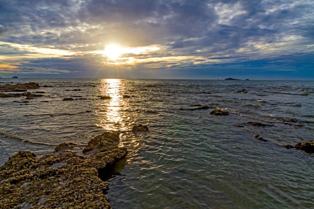 istock Sunrise on water in morning day cloudy at beach 1418047260