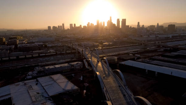 Los Angeles Skyline and Sixth Street Bridge with an empty road Aerial View of Los Angeles at Dusk as seen from East LA's 6th Street Viaduct Bridge. sixth street bridge stock pictures, royalty-free photos & images