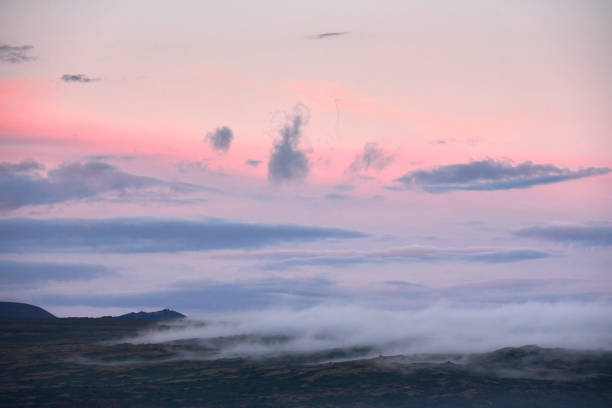Bright pink sunset sky over mountainous valley in Thingvellir, Iceland