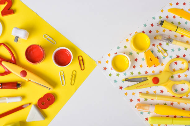 istock Various red and yellow stationery are lying in different corners on a white background. Back to school. Space for copying. Flat position, top view. 1418052611