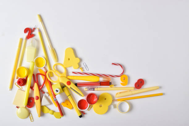 istock Various red and yellow stationery items are in the lower left corner on a white background. 1418052697