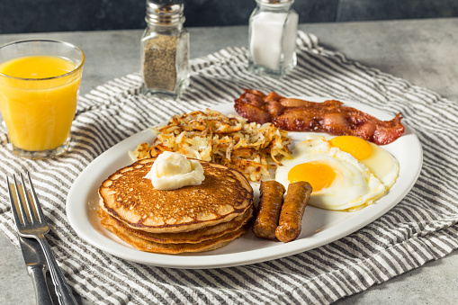 Full Homemade American Pancake Breakfast Brunch with Eggs Bacon and Hashbrowns