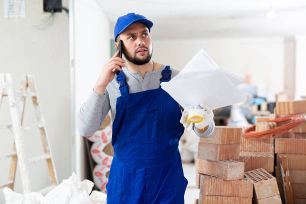 Mover with documents is talking on a mobile phone stock photo