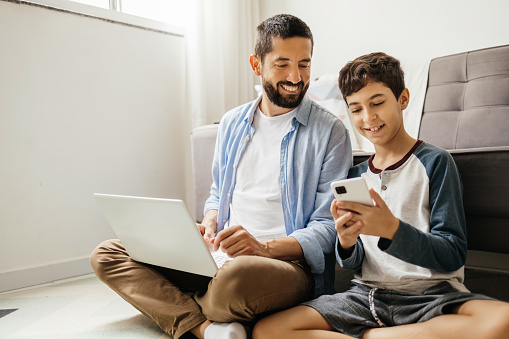 Father and his teenage son spending time together at home.