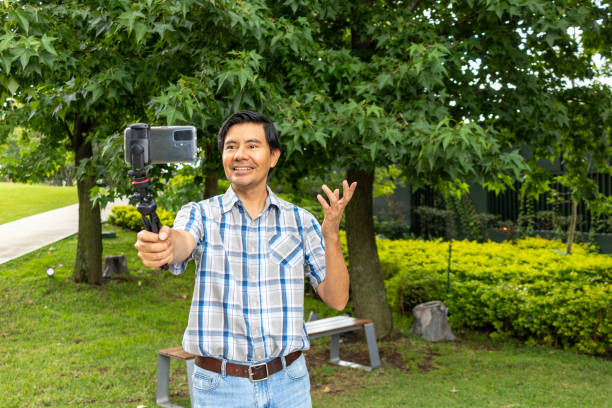 istock Influencer streaming live in a park. Social media concept 1418058831