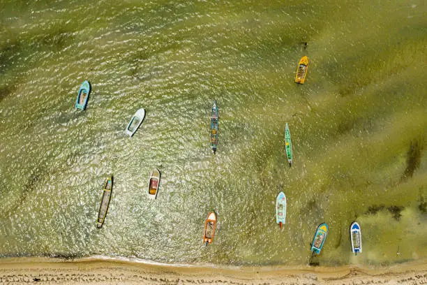 Photo of Aerial drone of Beach with fishing boats.