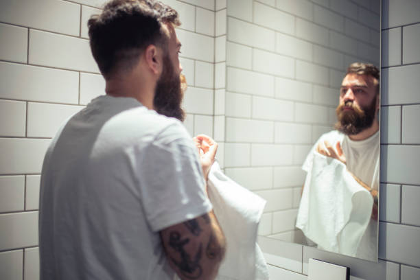 istock A millennial man wipes his hands with a white towel. 1418063602