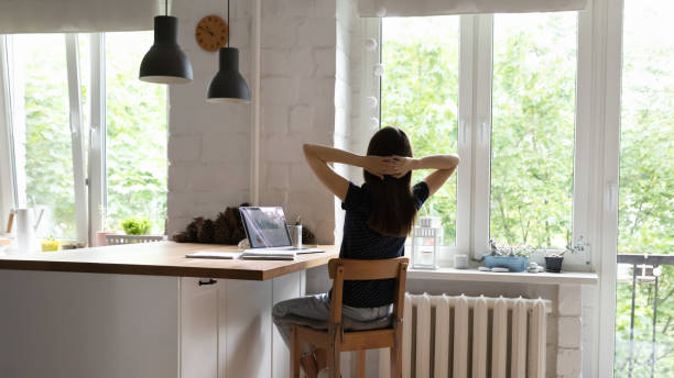 istock Relaxed freelancer girl stretching body at home office table 1418063639