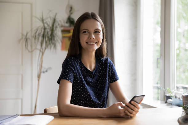 istock Cheerful millennial young woman using online app on smartphone 1418063648