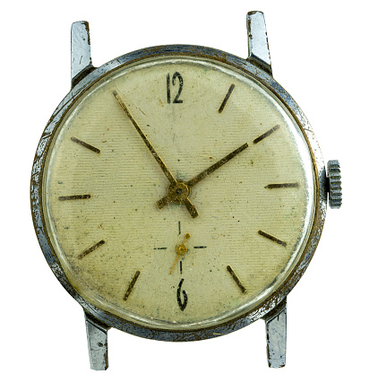 The dial of an old mechanical watch on a white background