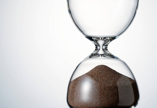 istock An hourglass placed on a white background. 1418072325