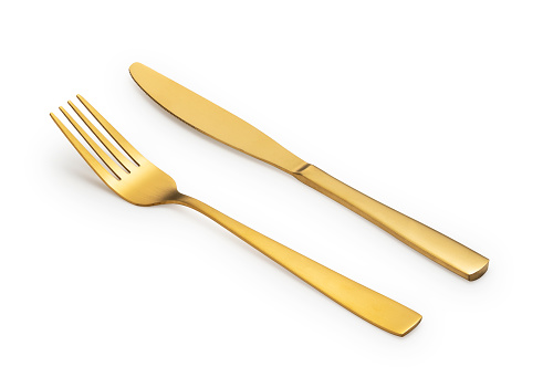 Gold knives and forks placed against a white background. Beautiful gold cutlery.