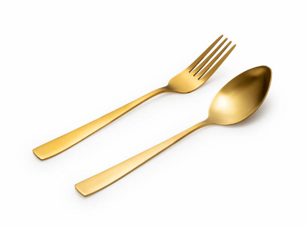 istock Gold spoons and forks placed on a white background. 1418072459